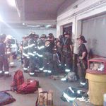 Firefighters seen here "extricate trapped occupant from the car down a parking garage elevator shaft," according to the FDNY.